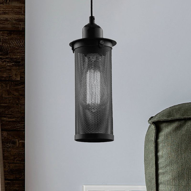 Black Sanna metal mesh pendant beside a green upholstered chair