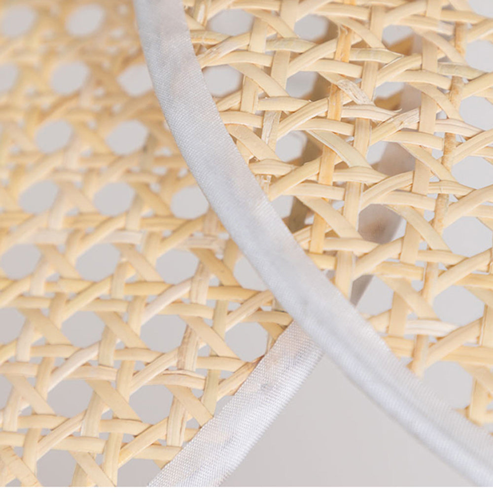 Close-up of beige woven strips with rounded open holes and white textured bands along the petal edges