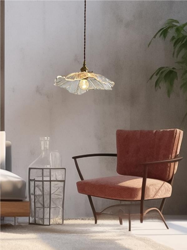 Clear lotus pendant above living-room seating