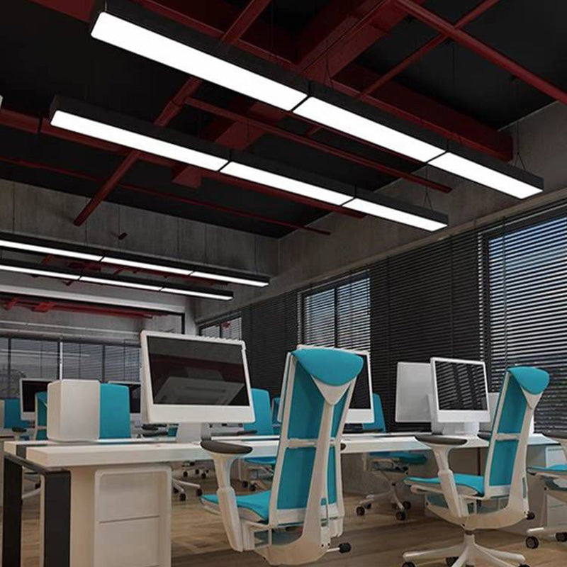 Long linear lights suspended above a desk area