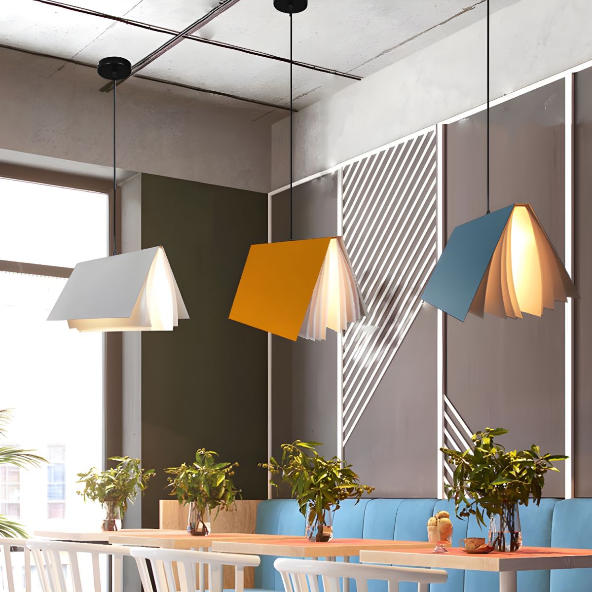 White, yellow and blue book pendants above a long table