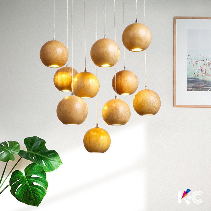 Wooden globes suspended at different heights in a bright interior