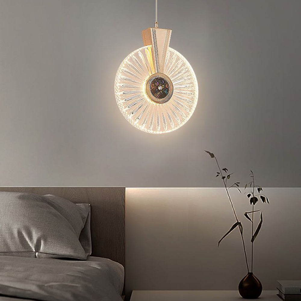 Radial round-disc pendant with a central medallion glowing beside a bed and tall vase