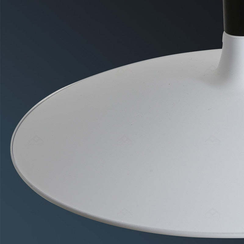 Close-up of the pale metal shade surface and thin circular rim against a dark blue background