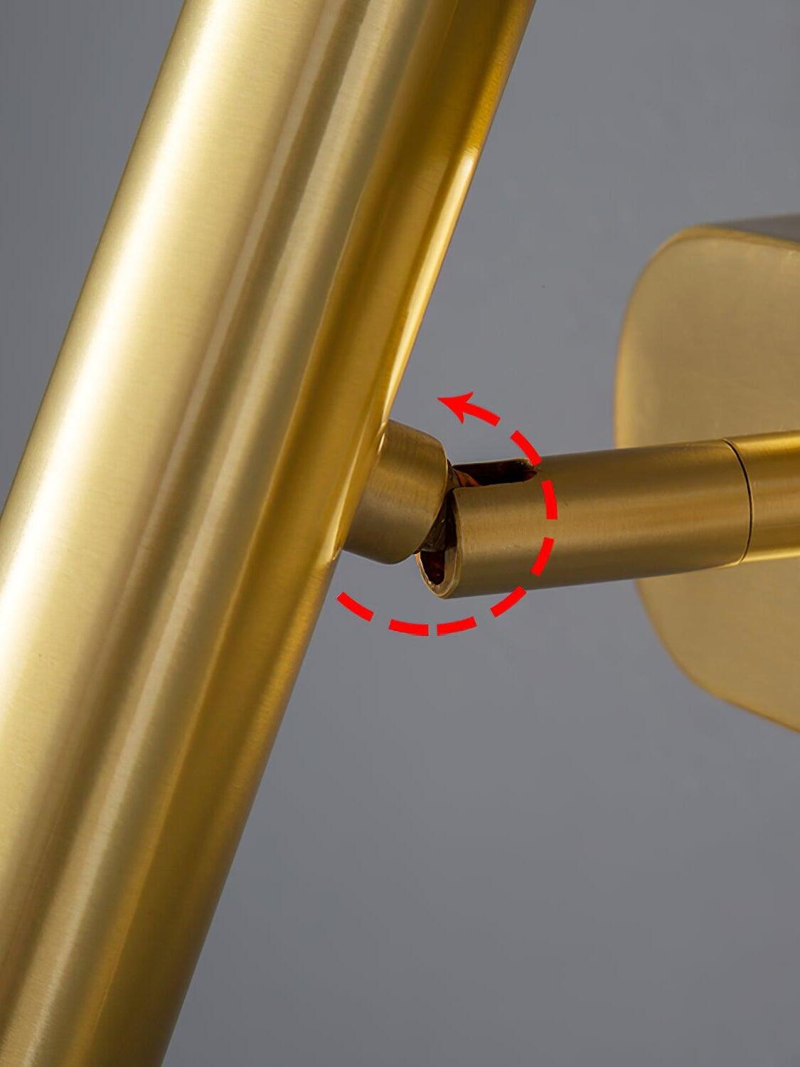 Close-up of the brass-coloured tube joint with a red curved arrow indicating adjustment