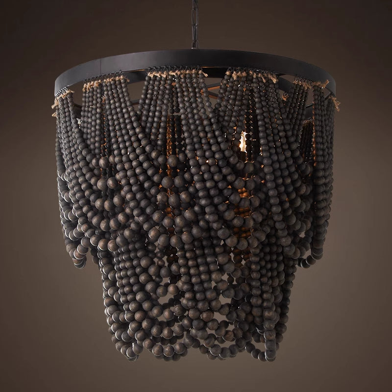 Dark beaded pendant illuminated against brown backdrop