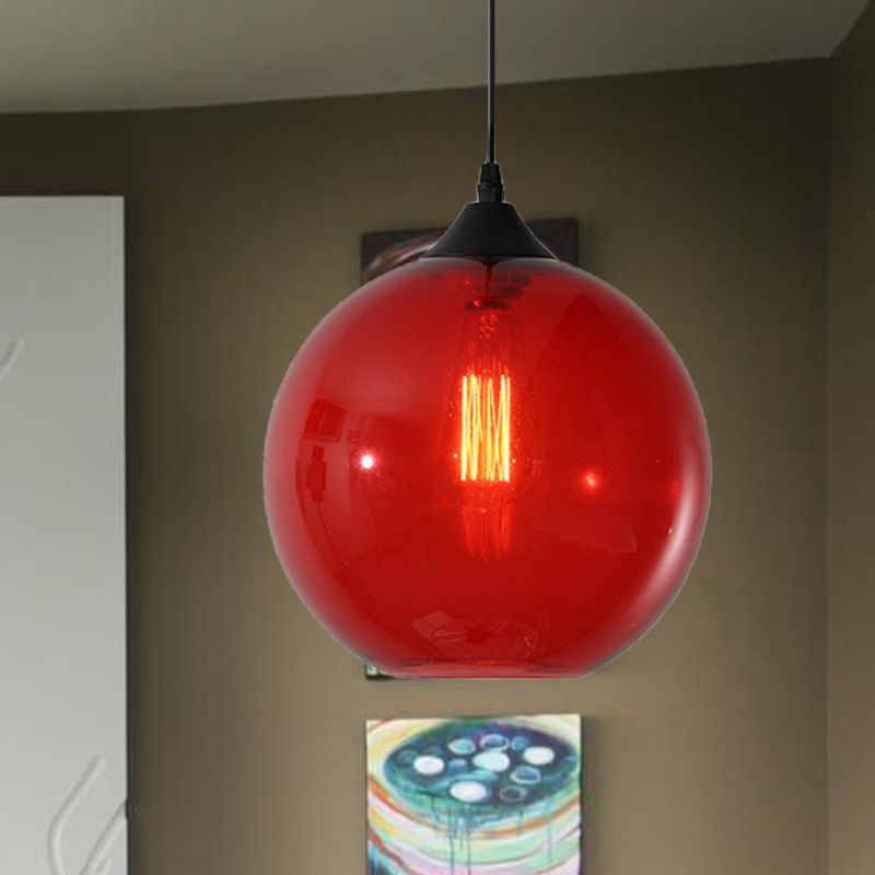 Red glass globe pendant against dark wall