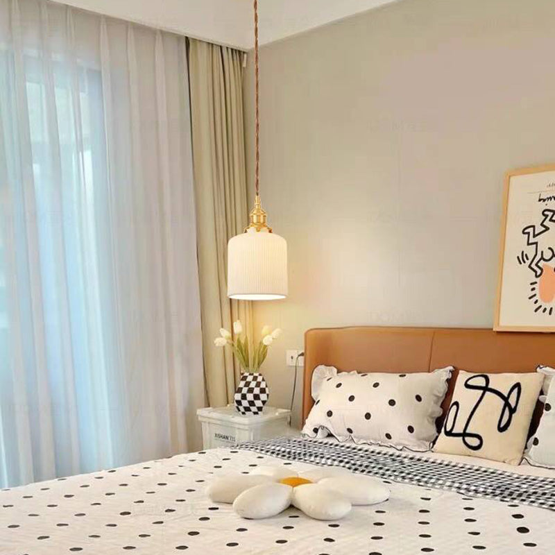 Valentina cylindrical pendant above a white bedside cabinet