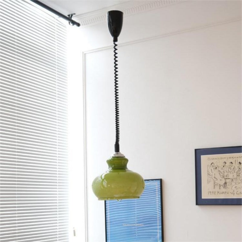 Green glass dome pendant in light room with framed print