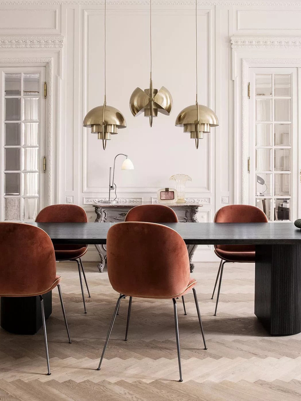 Copper-finish trio of pendants in a bright dining room