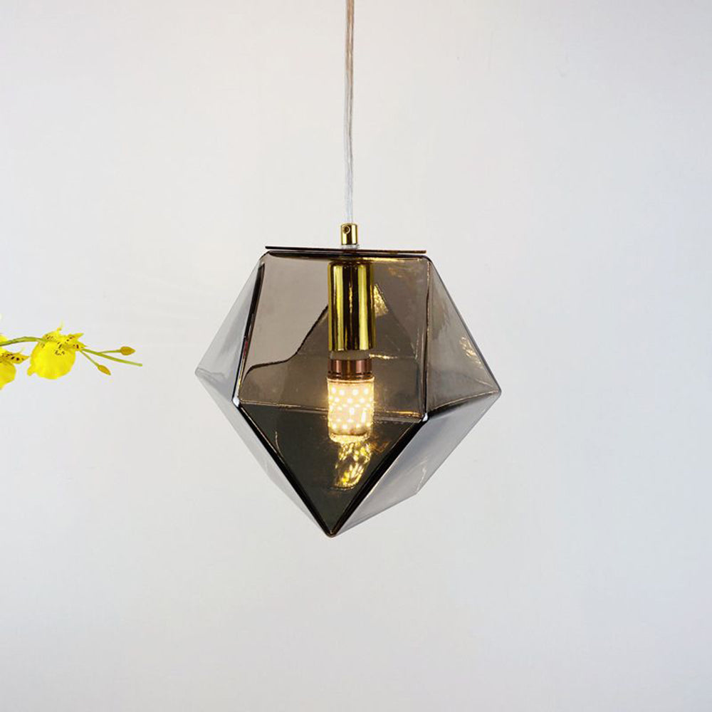 Hailie Smoke Gray angular glass pendant beside yellow flowers