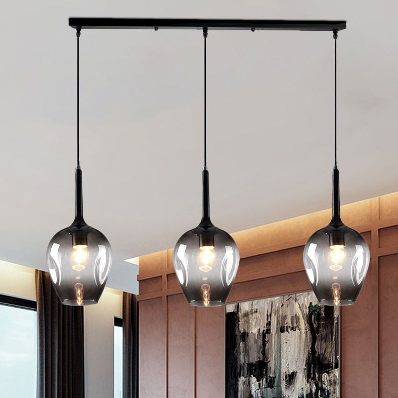 Hailie Gray glass pendant with three shades in a dining room
