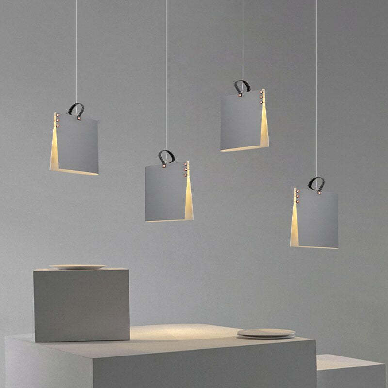 Four separate Gray Sienna upright file-holder style pendants with dark loop details above a gray counter