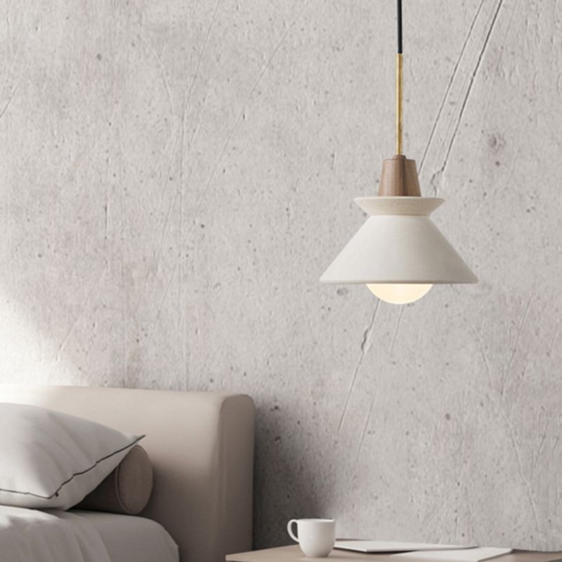 White Ozawa bowl-shade pendant hanging beside a sofa.