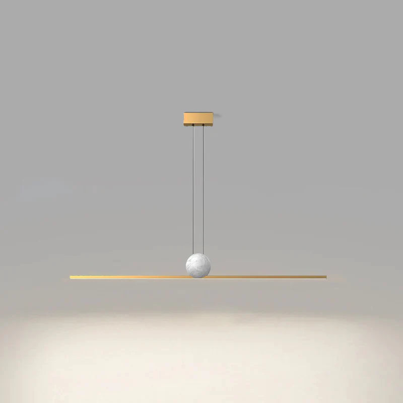 Gold Edge linear pendant glowing below a white marble-look sphere against a grey background.