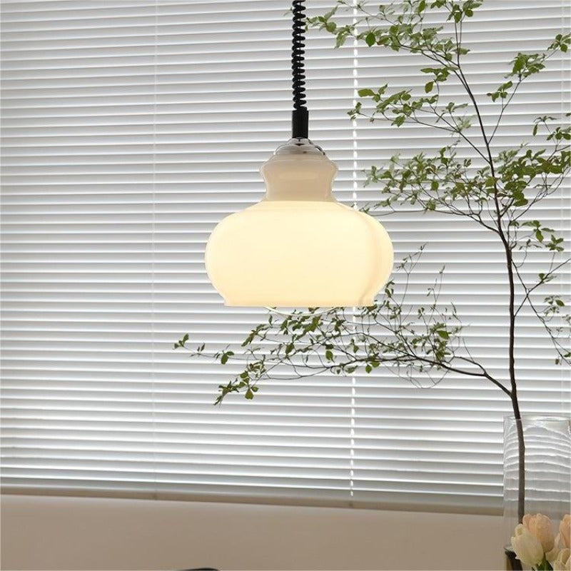 White glass dome pendant illuminated by window