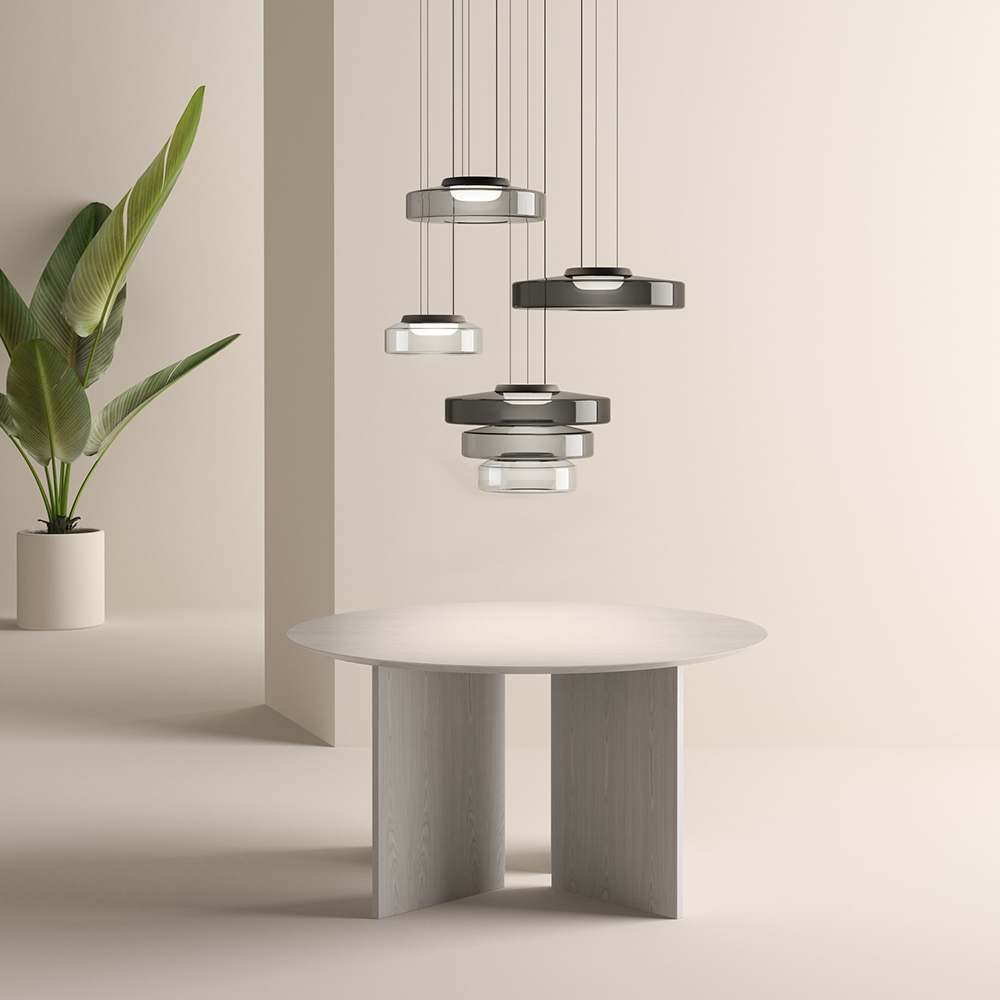 Different smoke-grey glass pendants displayed above a table