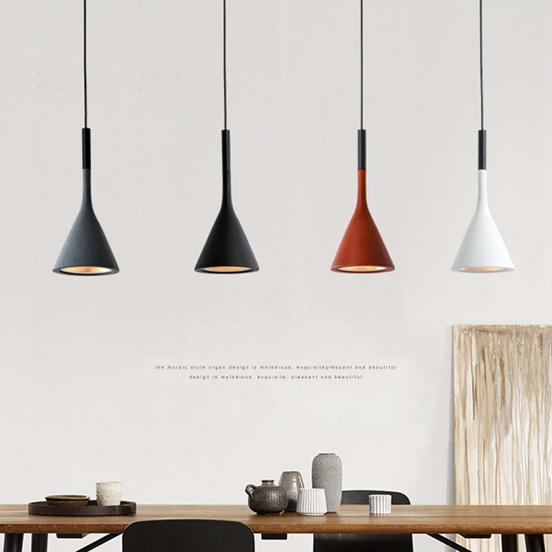 Four coloured cone pendants over long table
