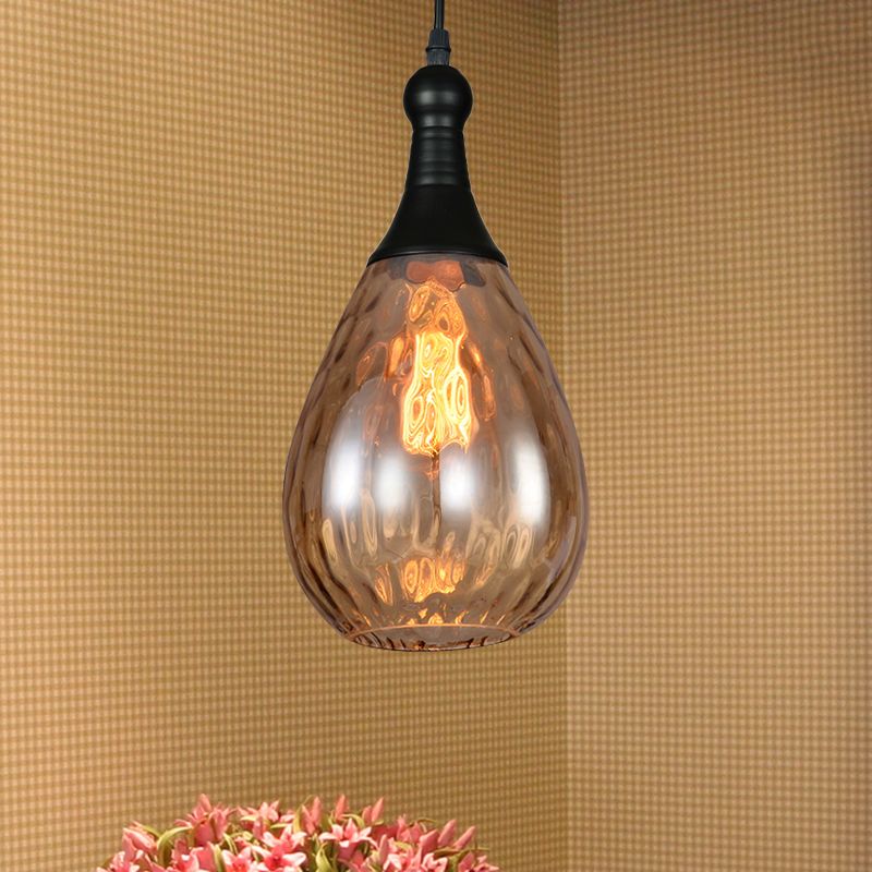 Avi Black-Amber glass pendant against a yellow wall
