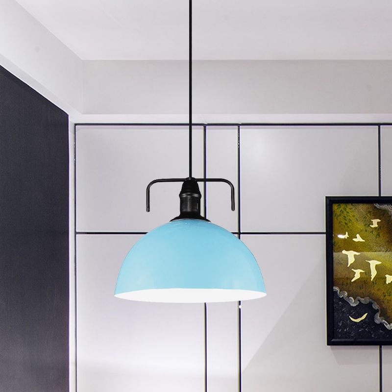 Sky blue dome pendant beside dark cabinet