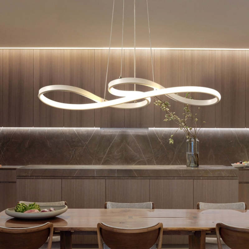 Gold loop LED pendant above a dining counter