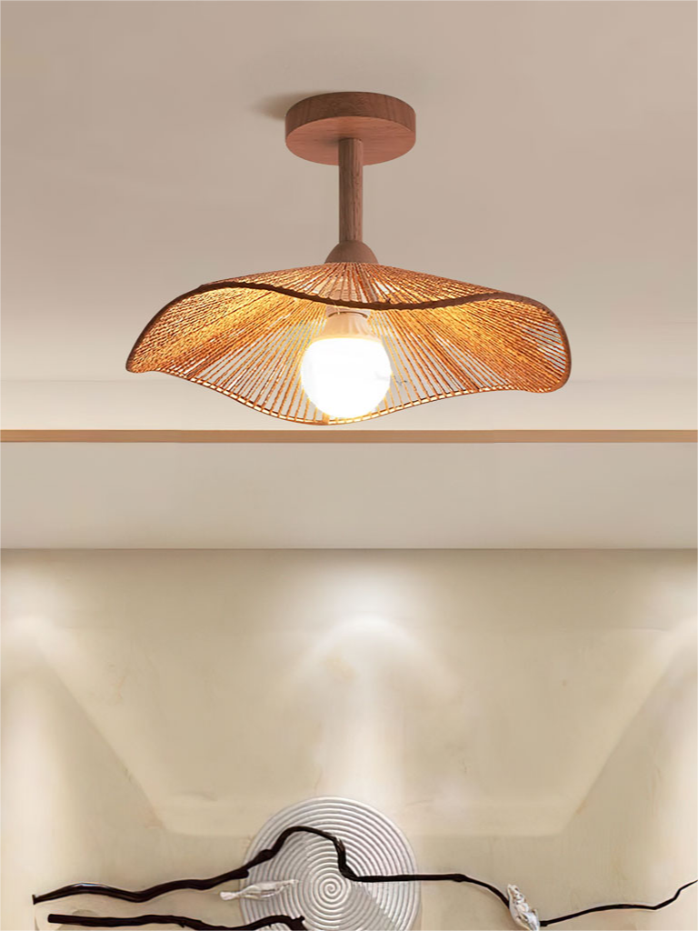 Hazel ceiling lamp viewed below a ceiling recess with wall spotlights in the background.