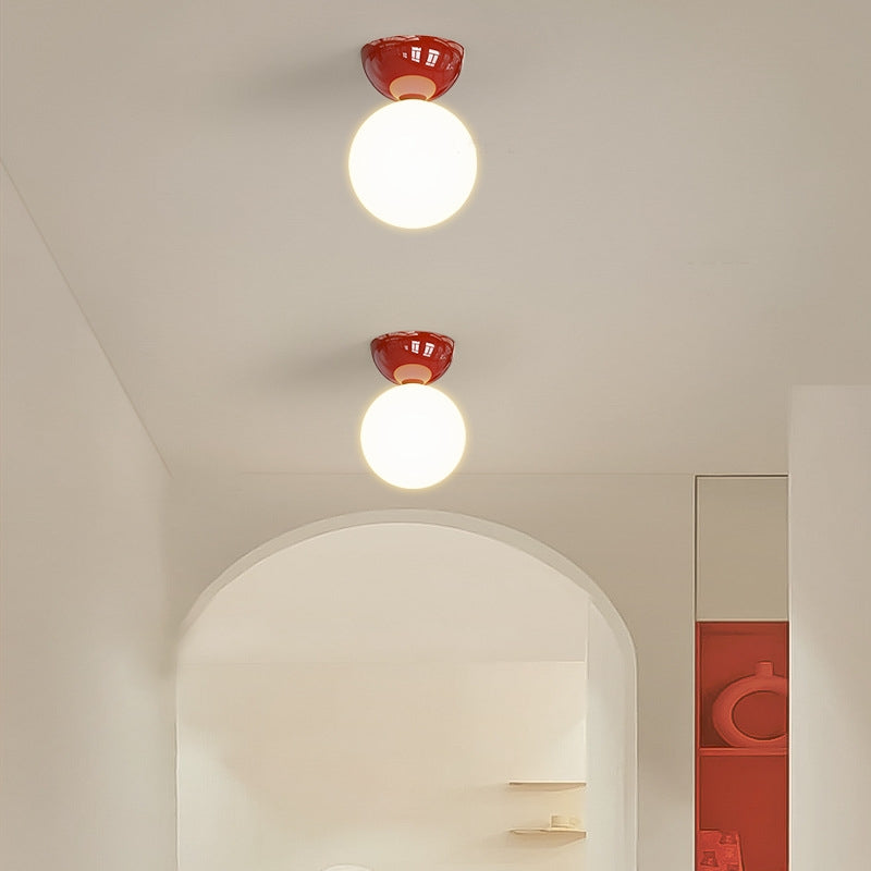 Red Valentina globe ceiling lights beside an arched opening