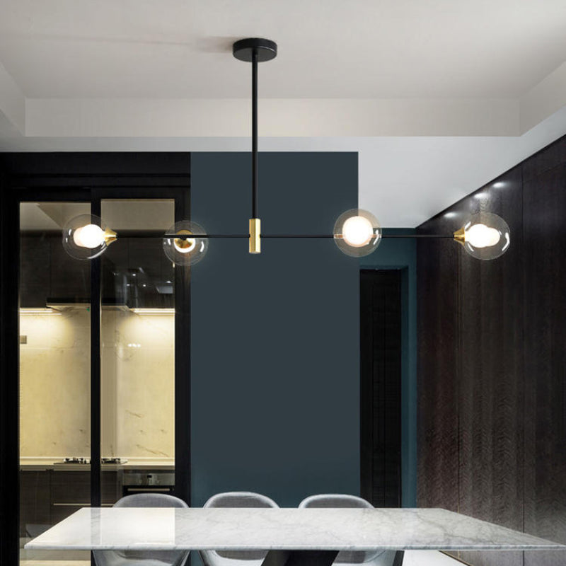 Four clear glass globes over a dining table