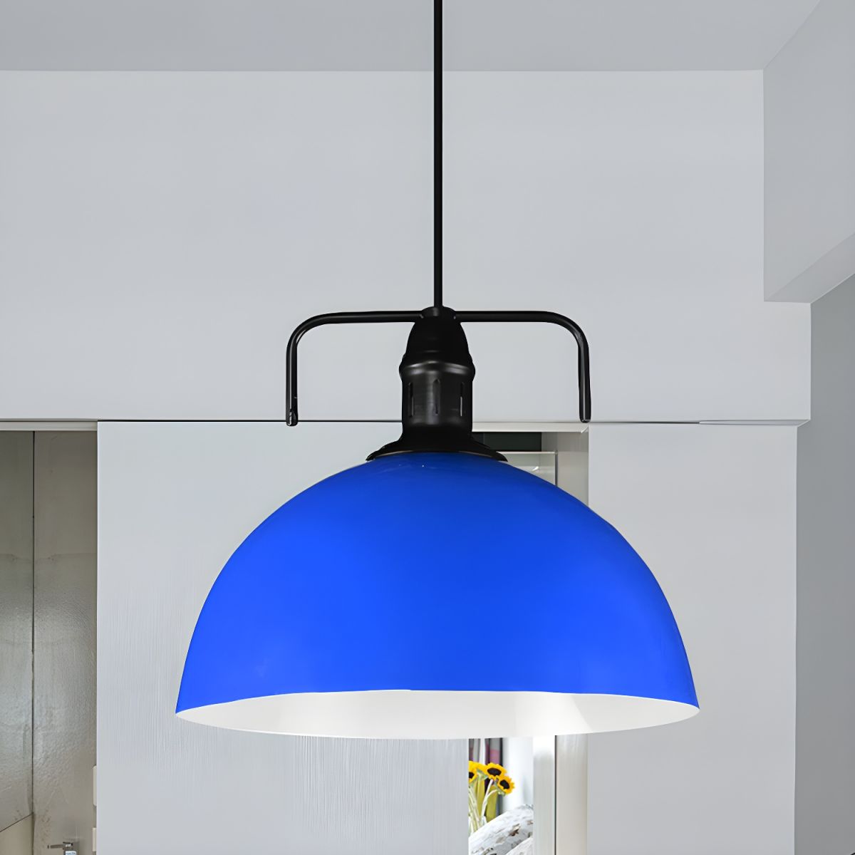 Dark blue metal dome pendant in pale room