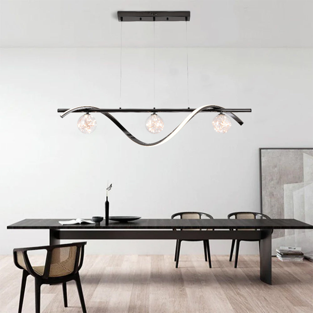 Black three-globe pendant above dark dining table