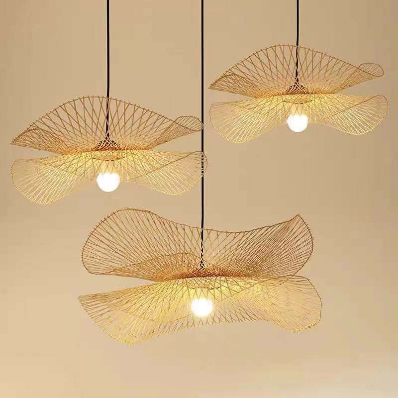 Three separate double-layer wavy woven pendants with visible lit bulbs against beige