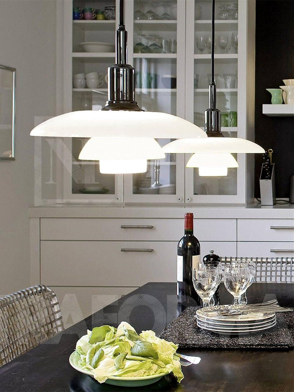 Two opal disc pendants above a black kitchen counter