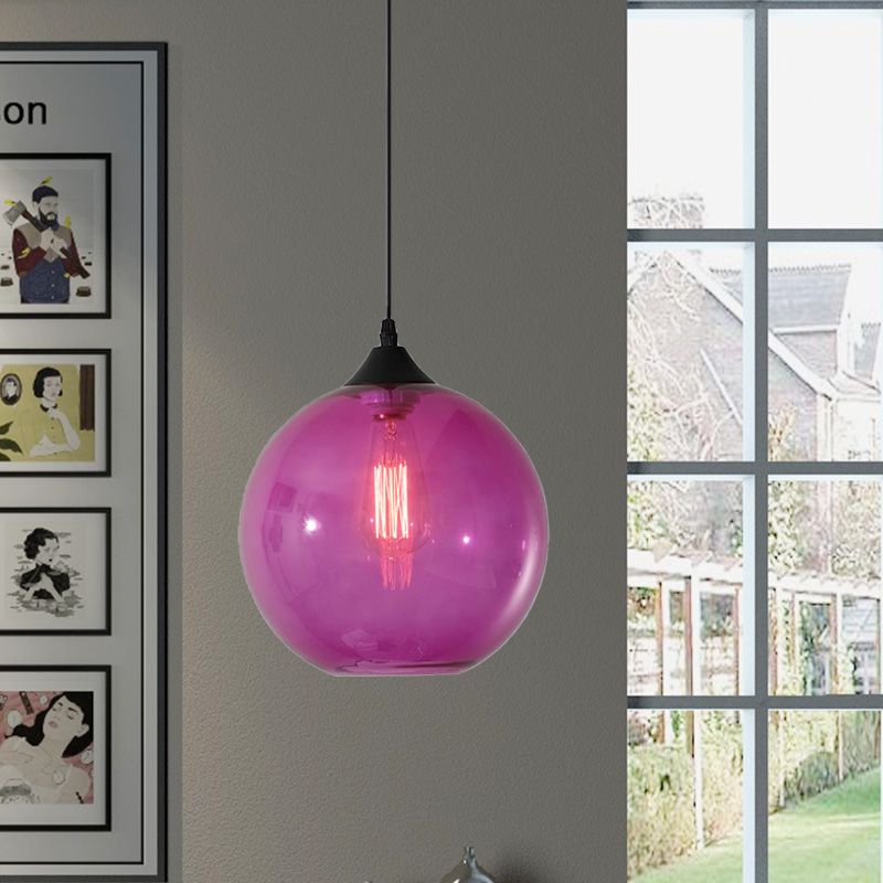 Purple glass globe pendant near a window
