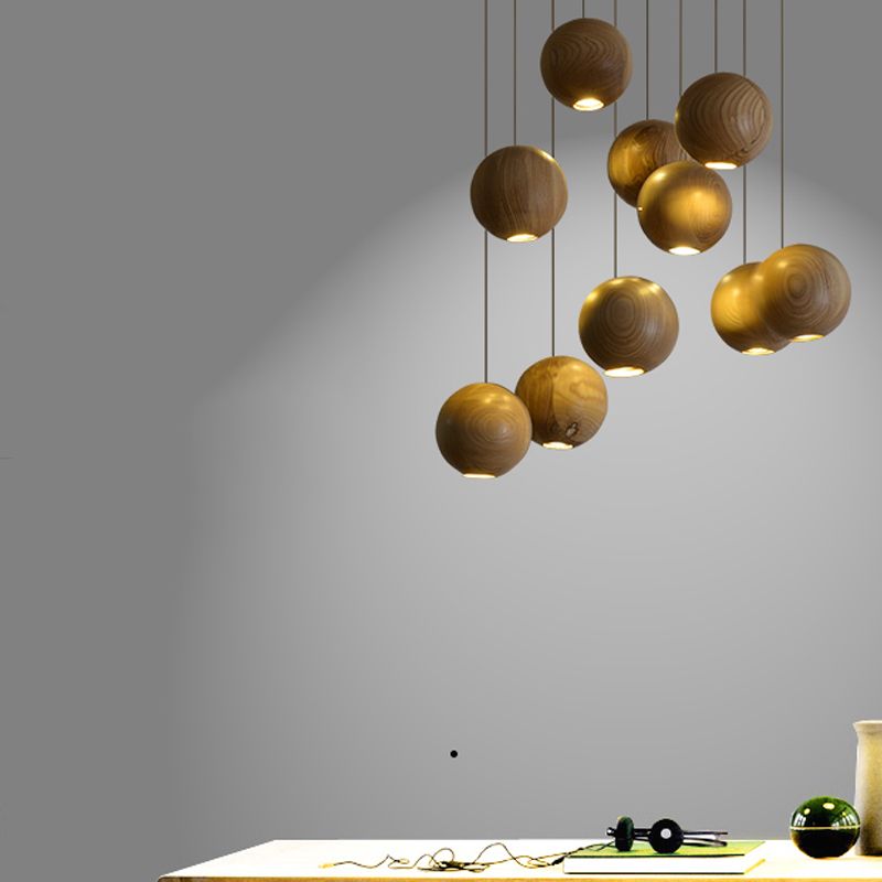Wood globe cluster hanging above a pale table