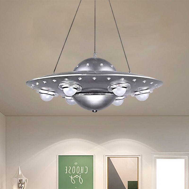 Alessio silver UFO pendant above framed wall prints