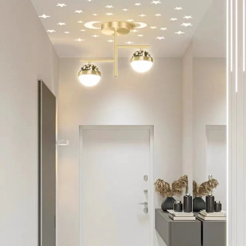 Gold A-style ceiling light near entry door with ceiling stars