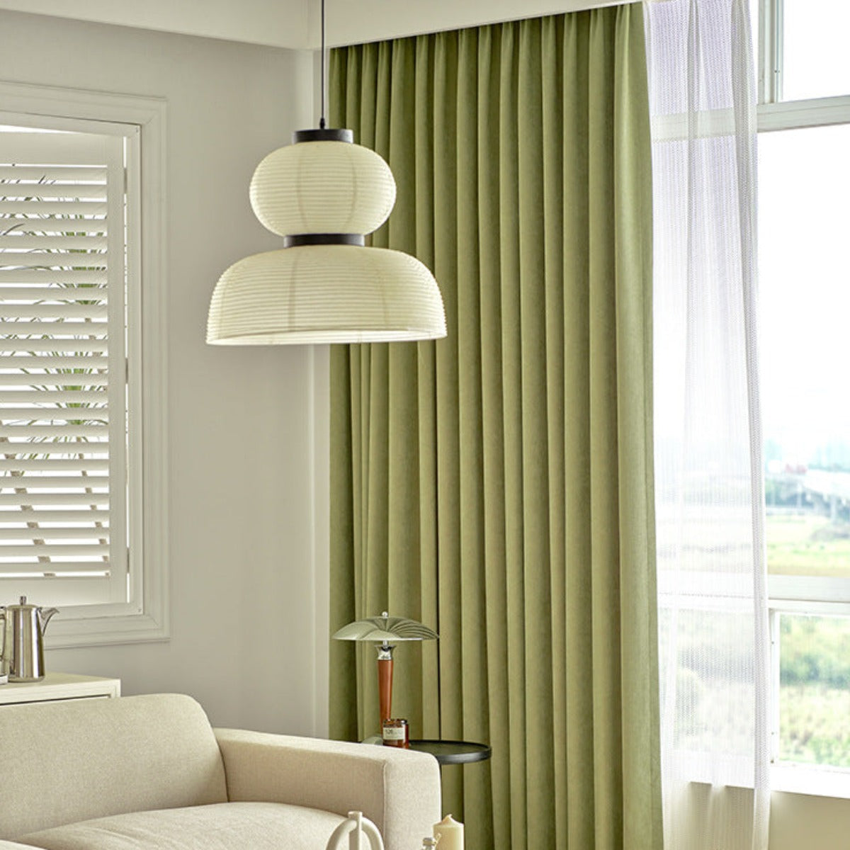Ozawa globe-over-dome fabric pendant above a white seating area
