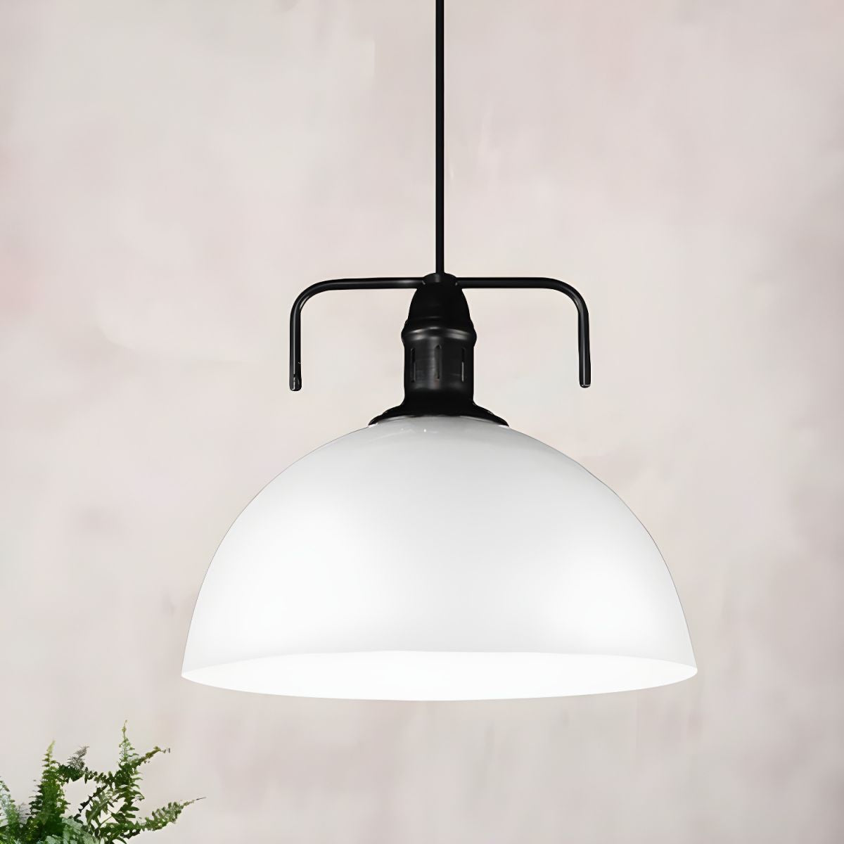 White metal dome pendant above plant
