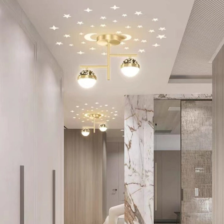 Gold two-globe ceiling light with another fixture farther down corridor