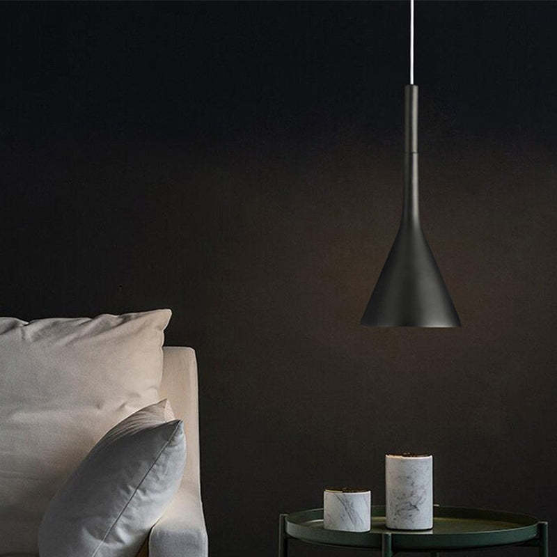 Unlit black tapered pendant beside bed