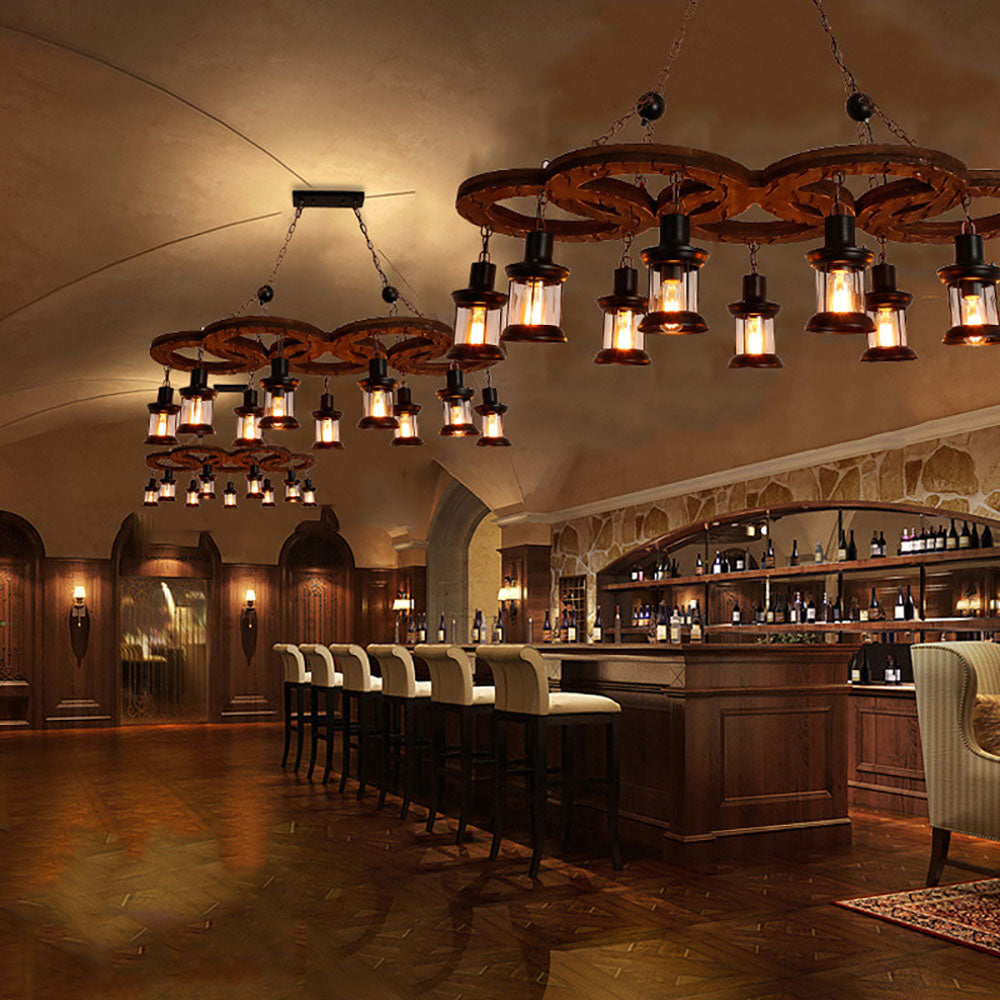 Austin ring lantern pendants over a wooden bar with cream stools and bottle shelves beneath a stone arch