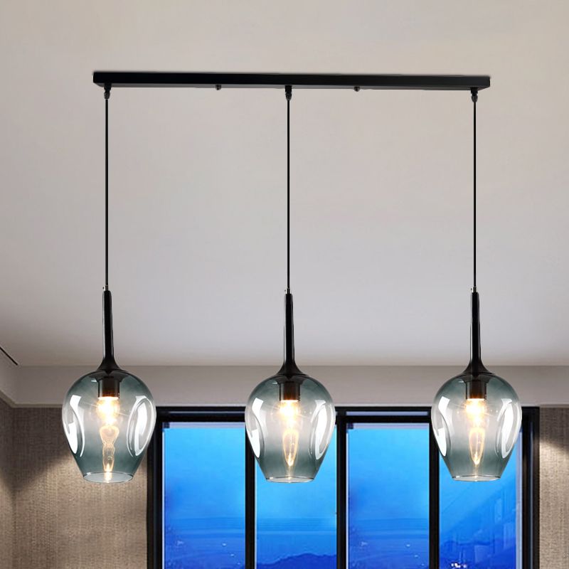 Hailie Blue variant glass pendant with three shades beside blue-lit windows
