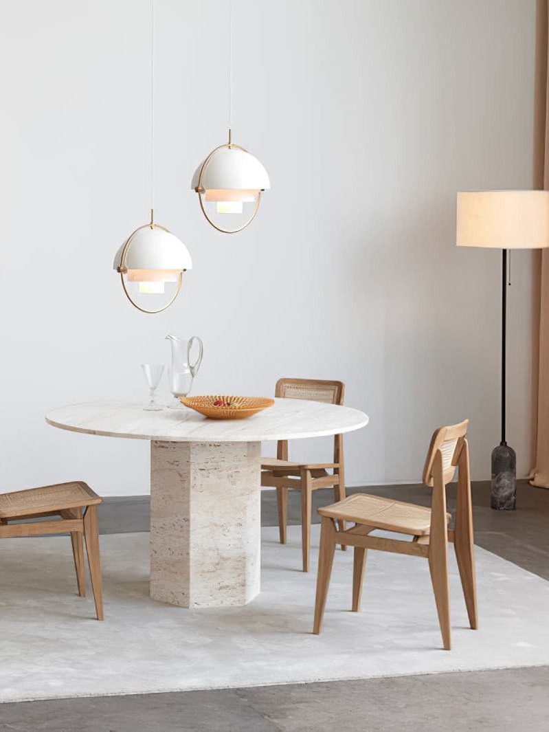 Pair of white dome pendants above a pale stone table