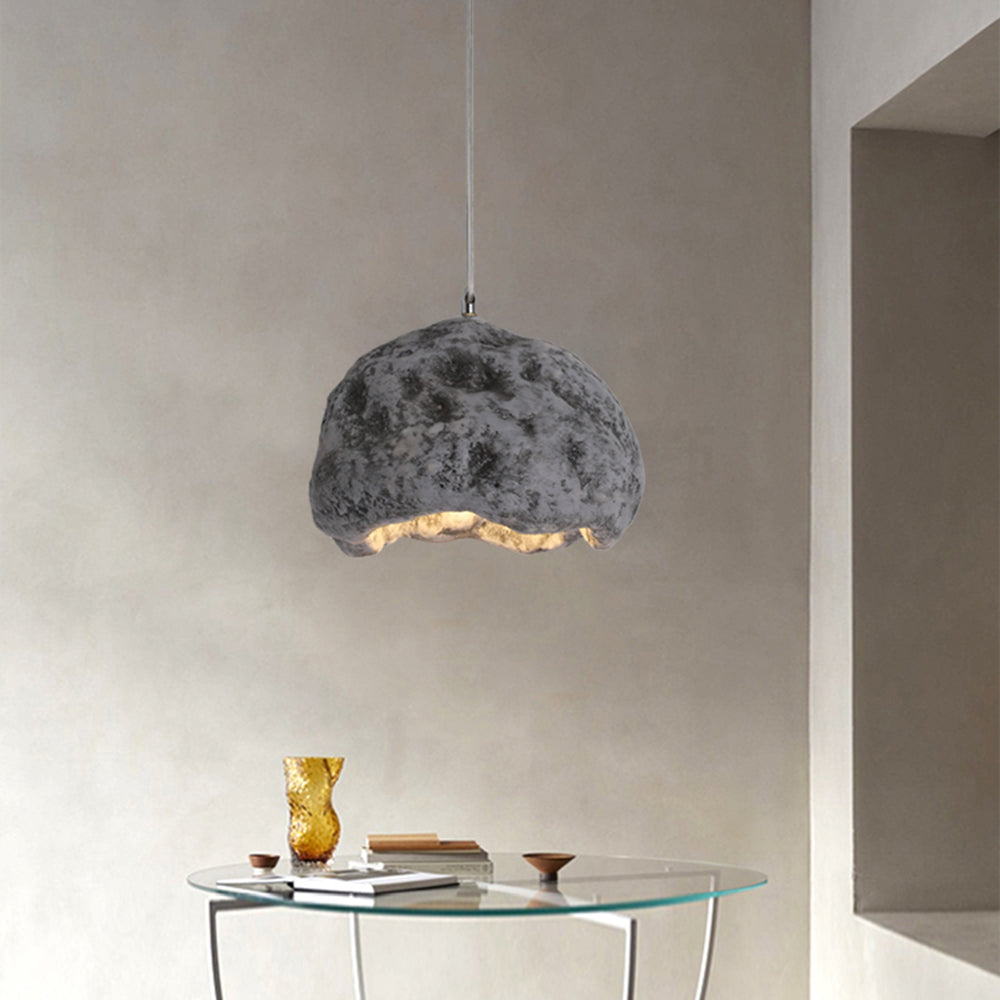 Gray Byers irregular dome pendant light above a glass-topped table