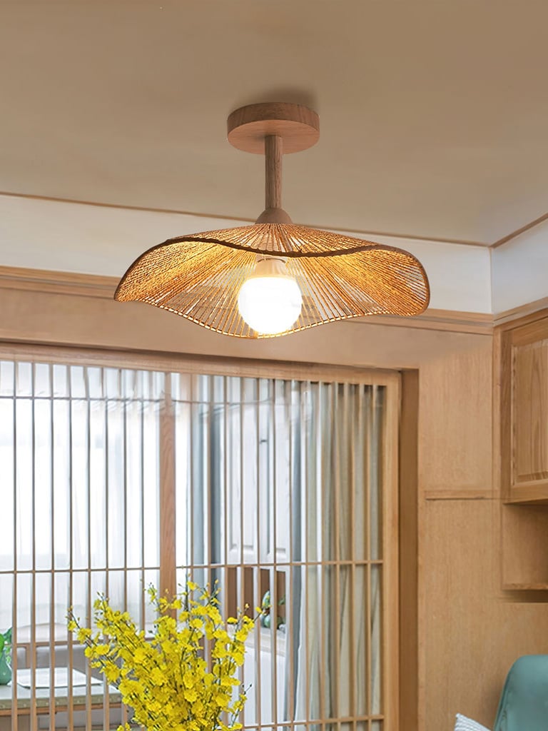 Walnut Color Hazel ceiling lamp beside tall windows and yellow flowers.