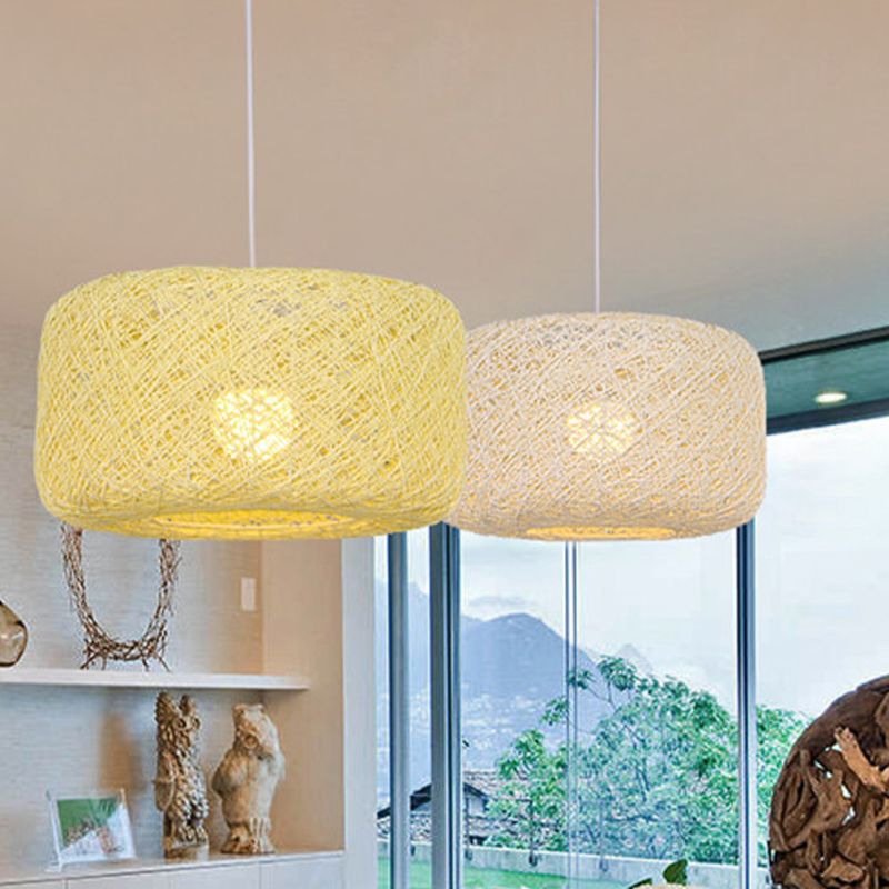 Two pale woven rattan pendants near window