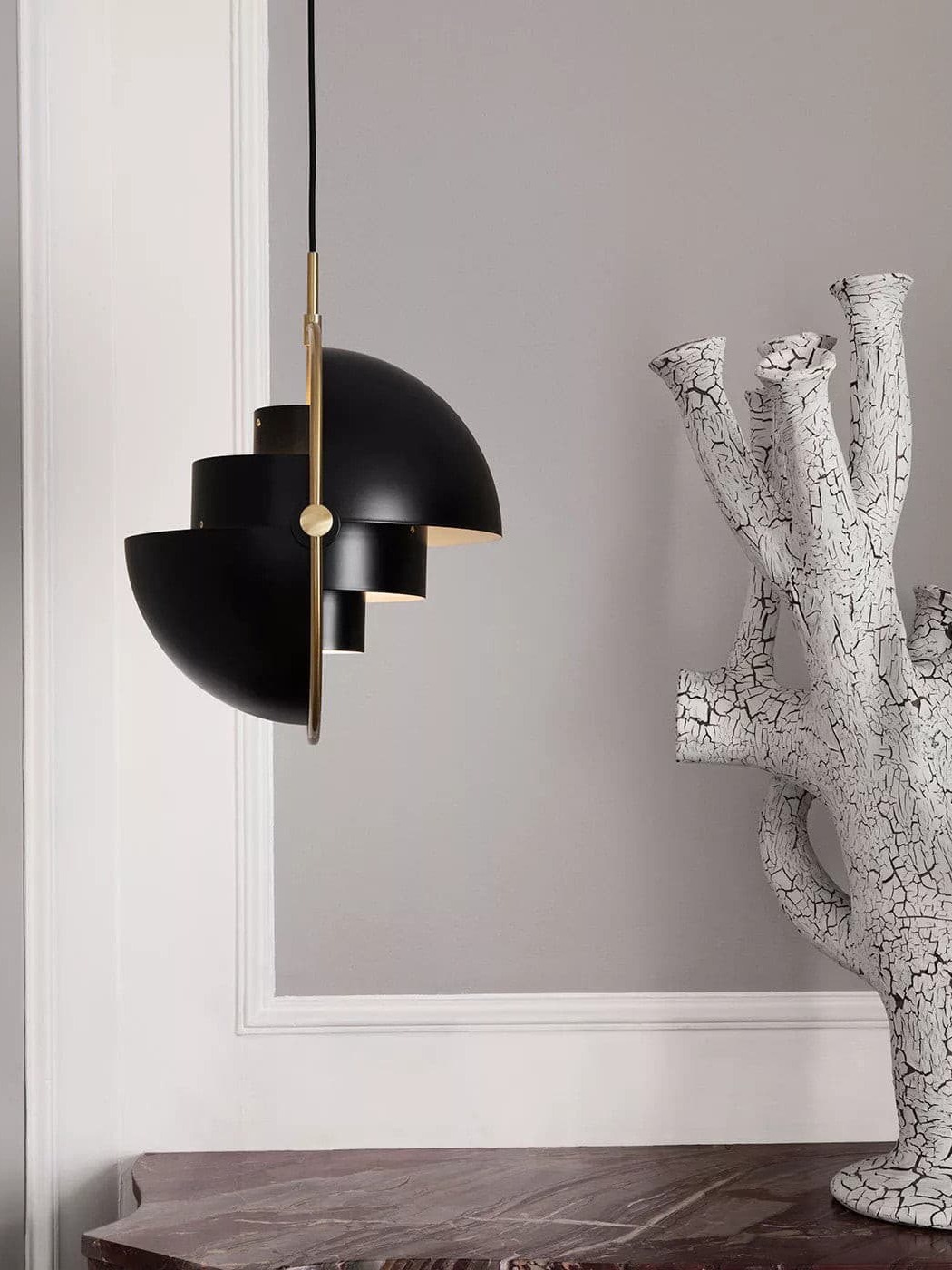 Black pendant with shade halves rotated in opposite directions