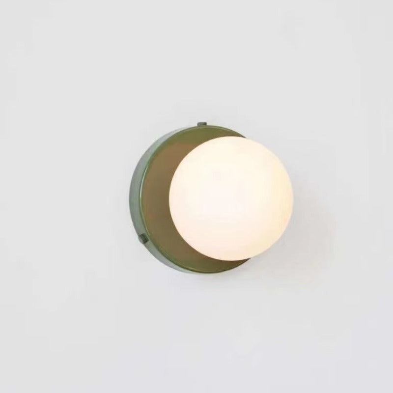 Green circular backplate with glowing white glass globe