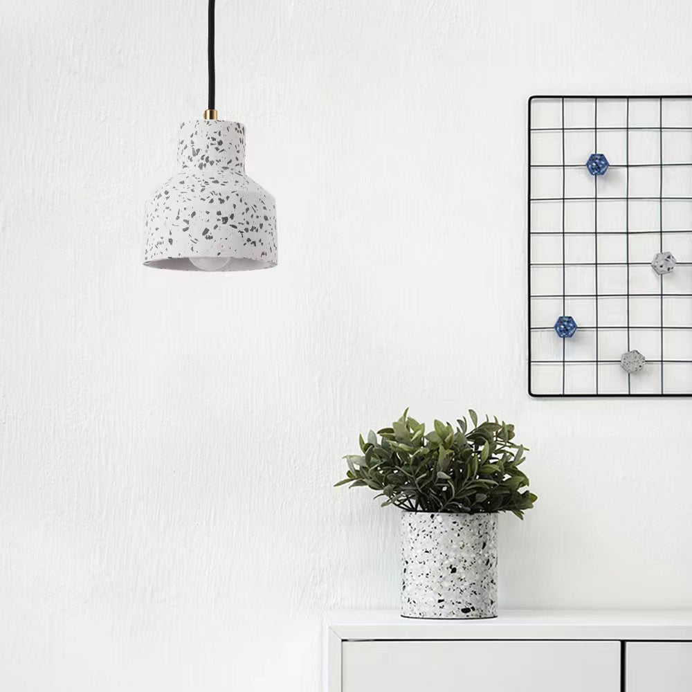 White Morandi speckled pendant over a white cabinet beside a matching speckled plant pot and wire-grid wall display