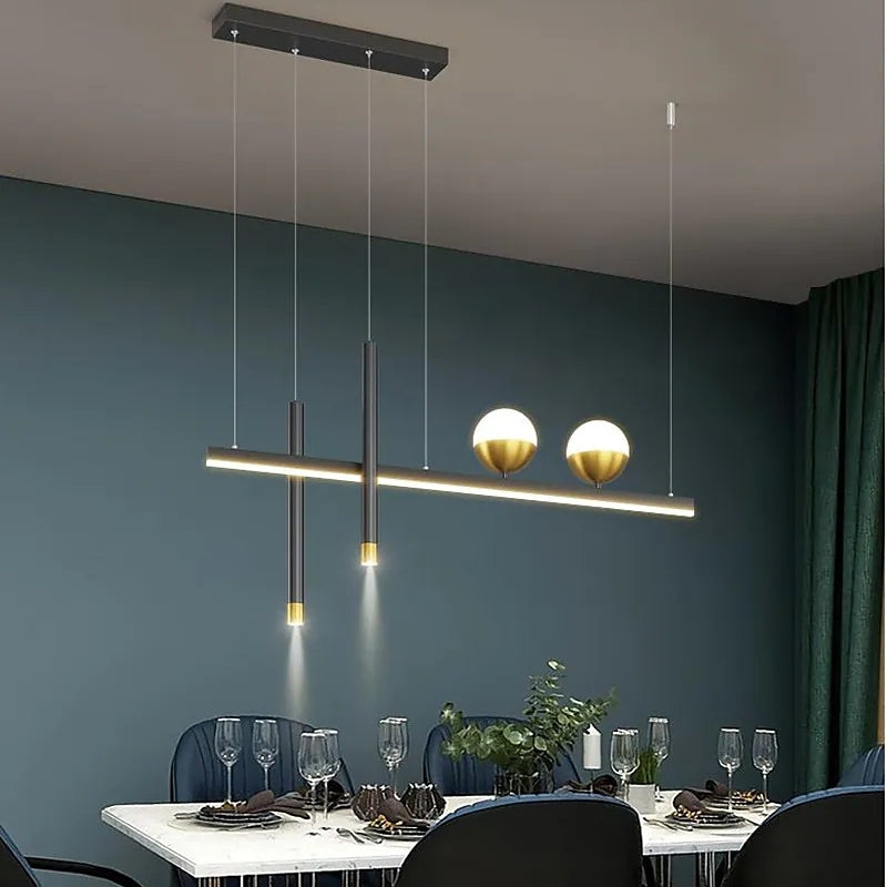 Madina linear pendant above a table against a green wall.
